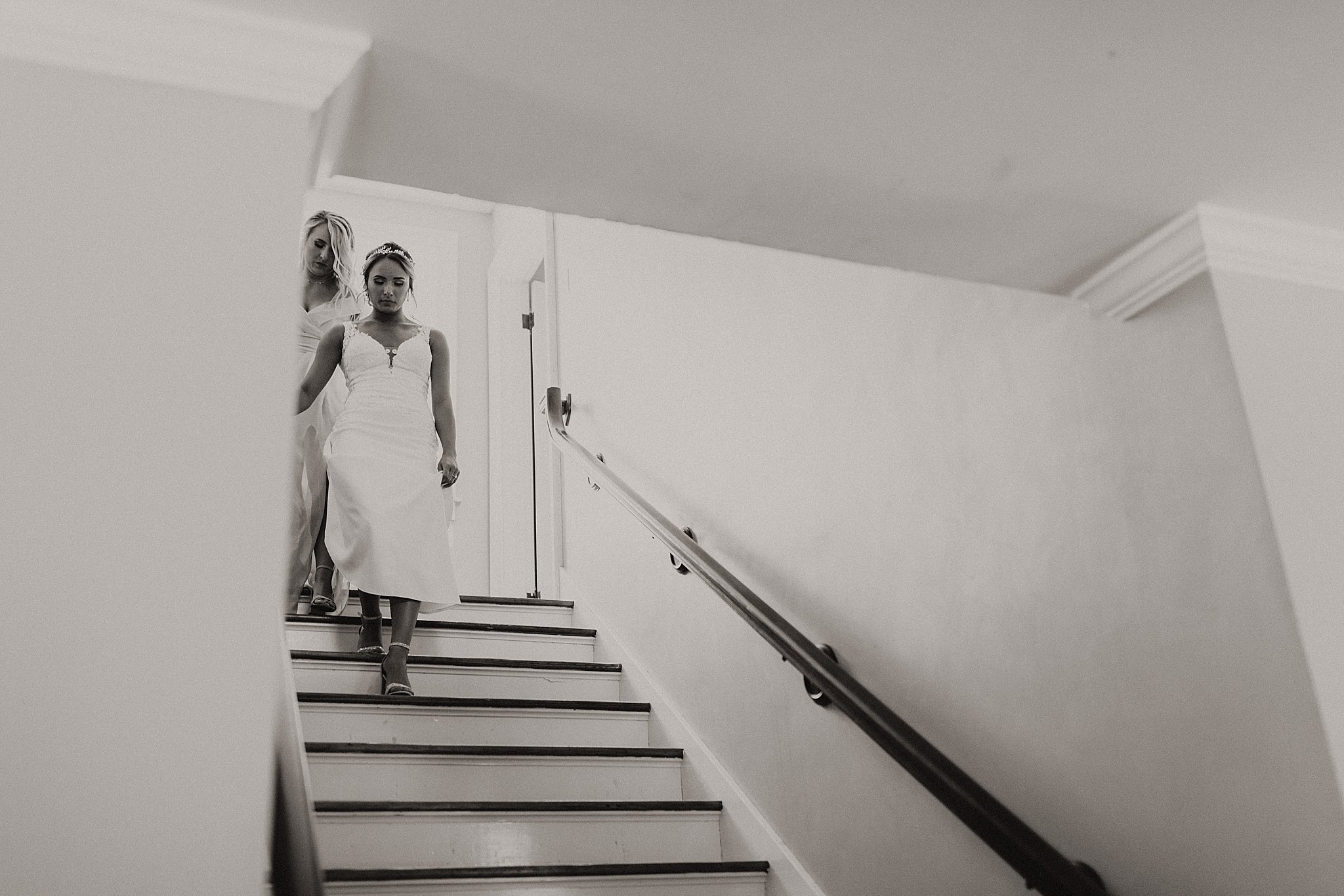 Bride walking down grand staircase