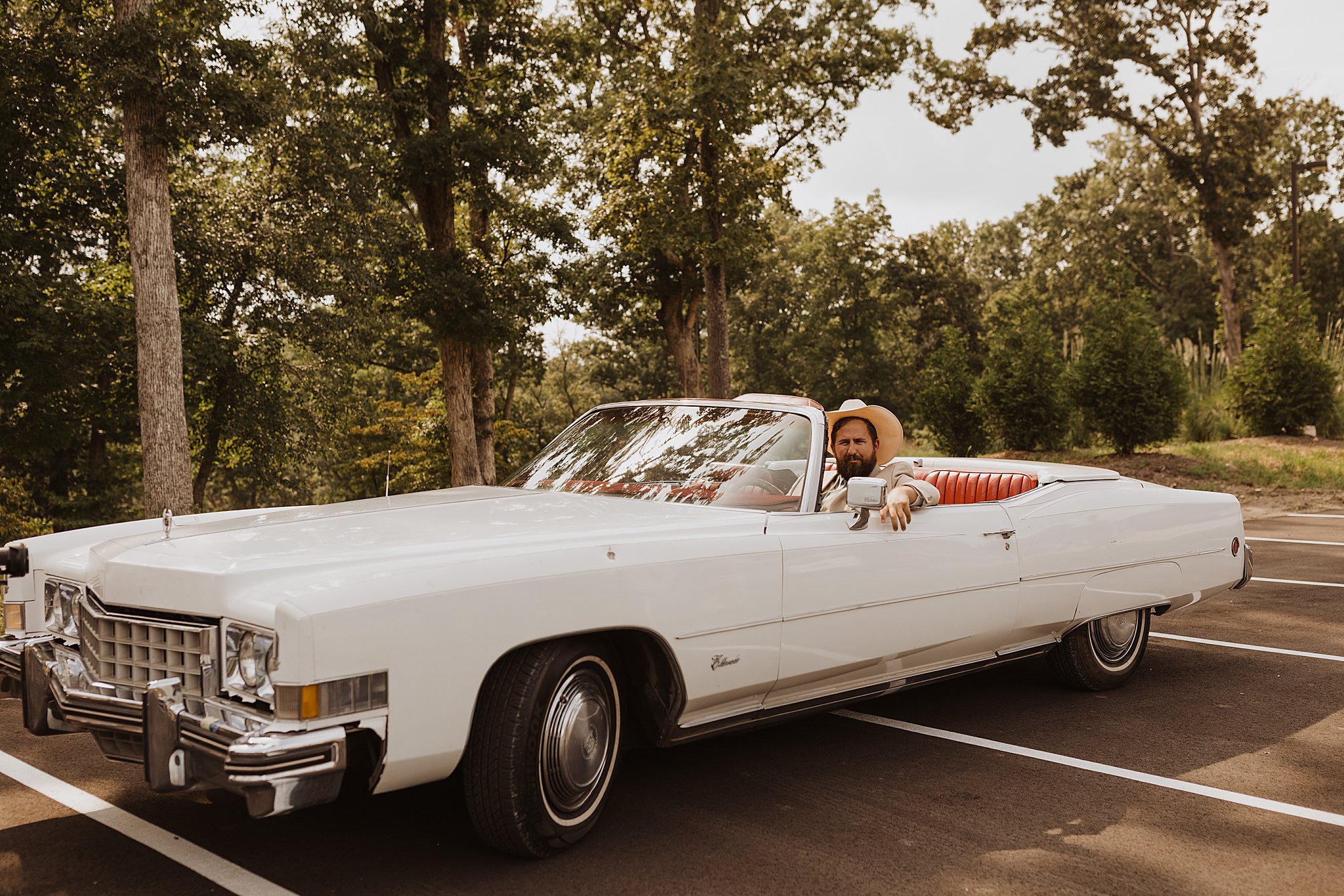Groom driving a Vintage Cadillac on Wedding Day