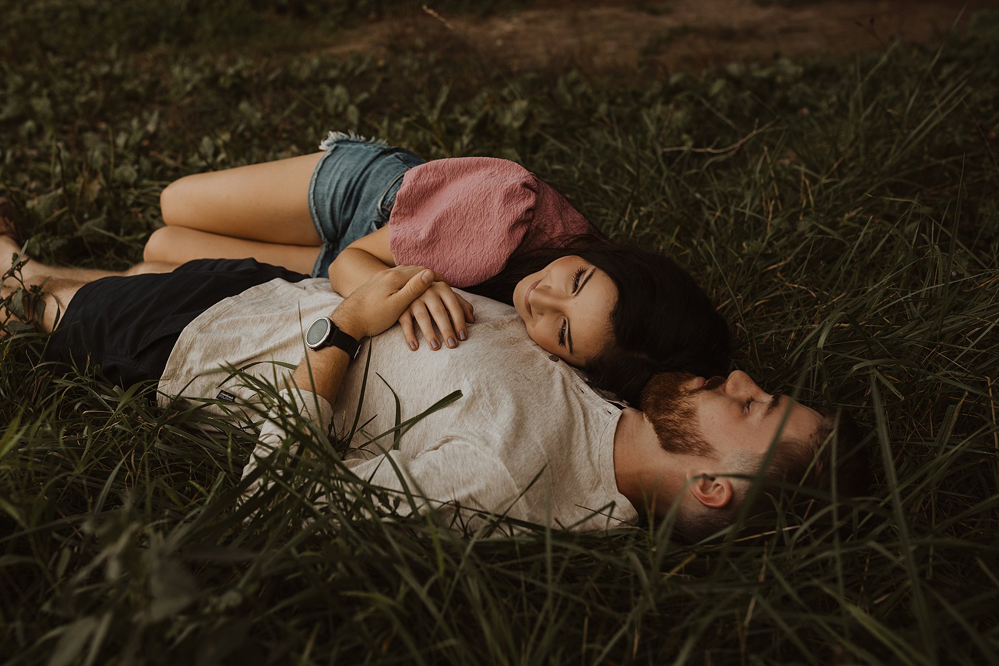 Romantic Engagement Photos | Couple laying in grass together