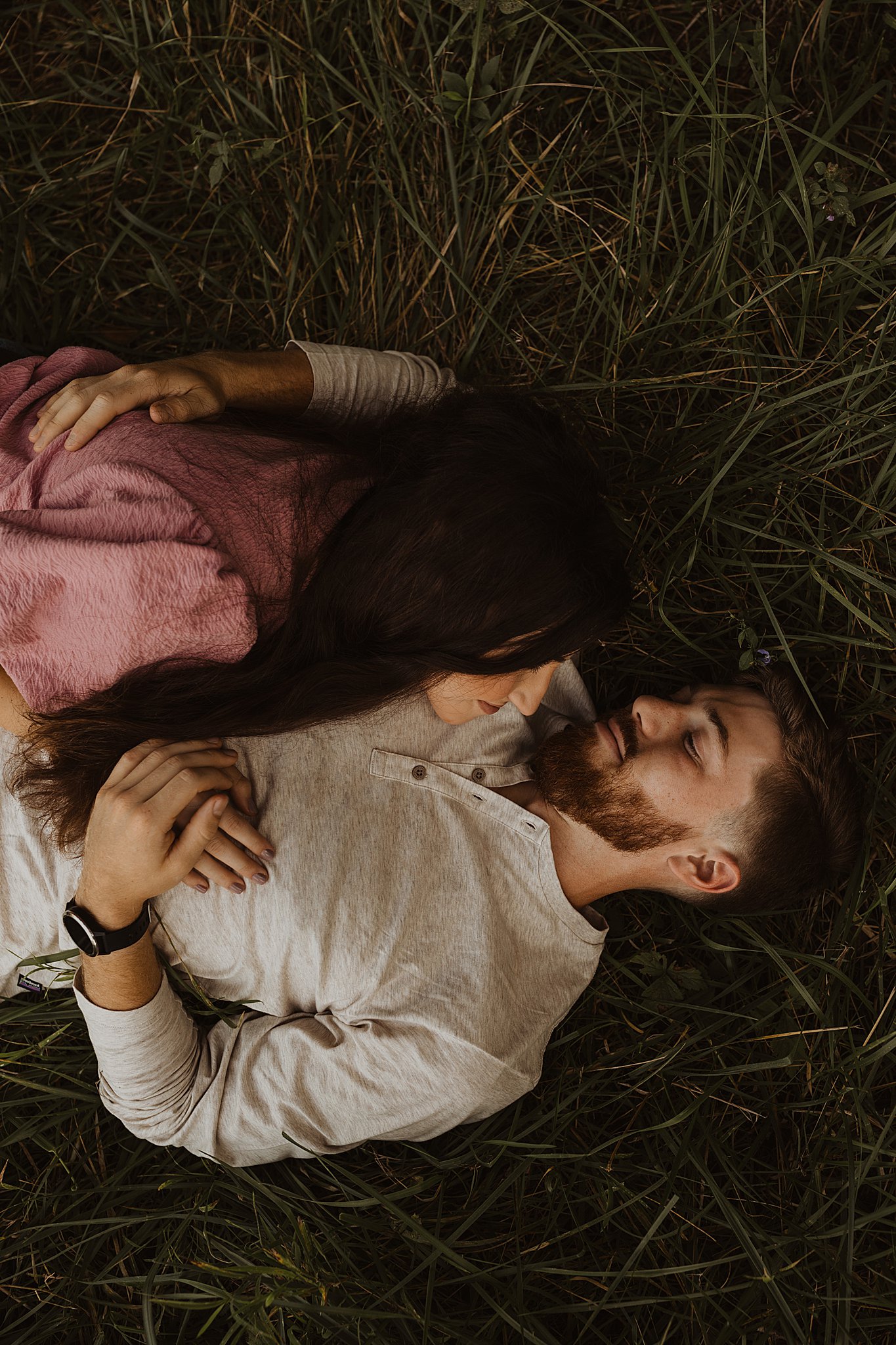 Romantic Engagement Photos | Couple laying in grass together