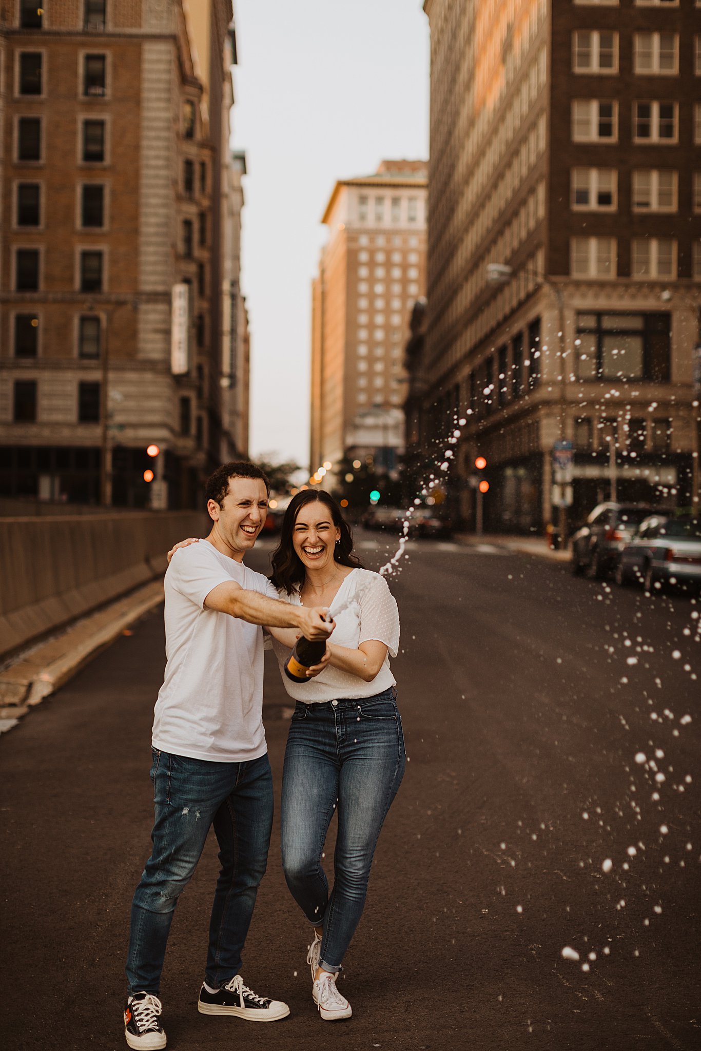 Couple popping champagne | Engagement photo ideas