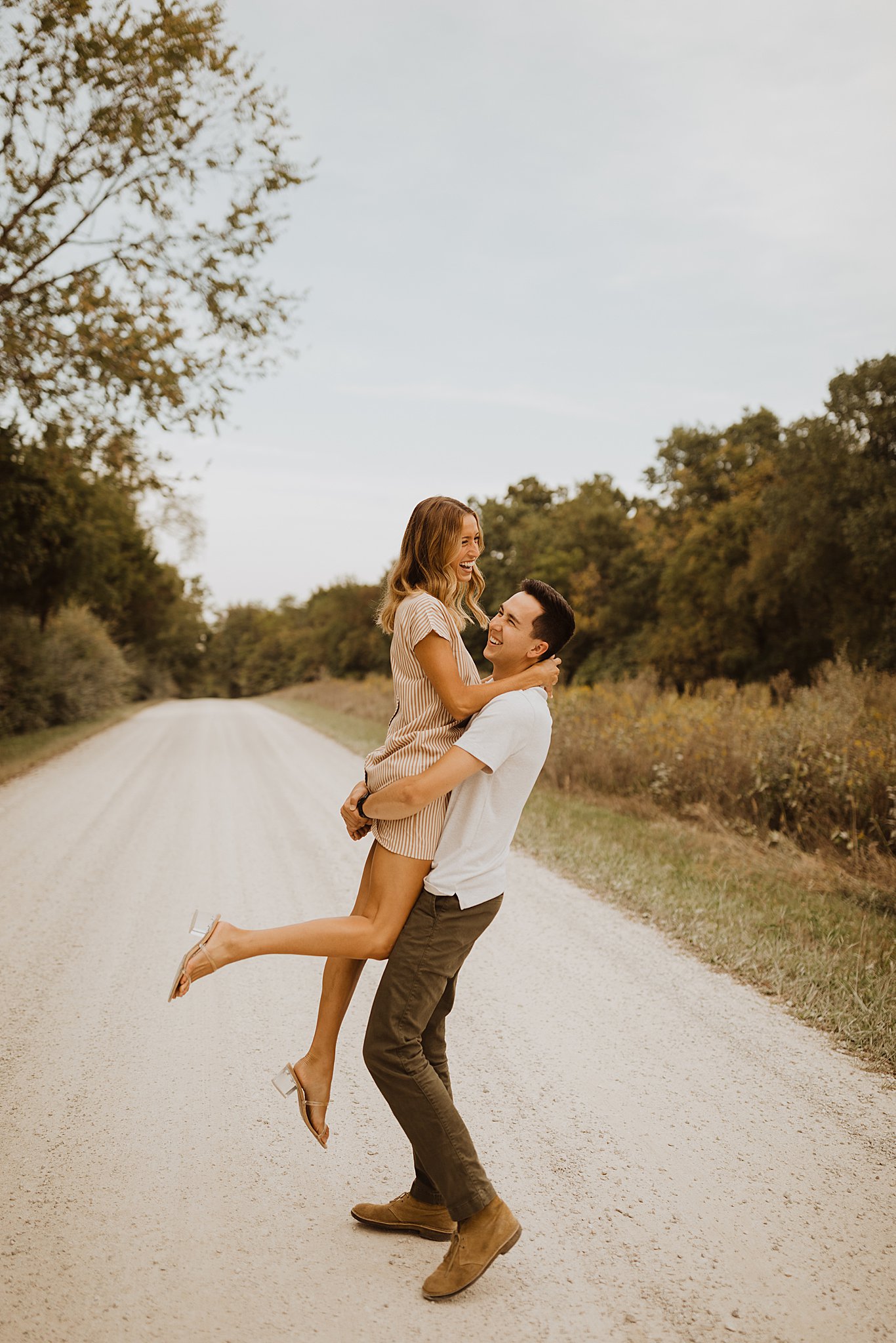 Couple twirling around on a gravel road in St. Louis