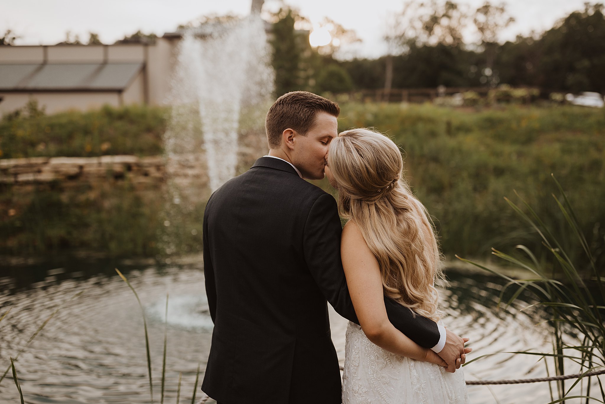 Bride and Groom Kissing in Front of Fountain at Silver Oaks Chateau