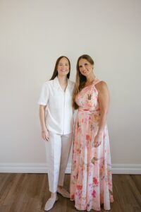 Brides celebrating their summer wedding at Wild Carrot in St. Louis with bridesmaids in pale yellow and chartreuse dresses and bridesmen in beige suits.