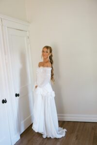 Brides celebrating their summer wedding at Wild Carrot in St. Louis with bridesmaids in pale yellow and chartreuse dresses and bridesmen in beige suits.