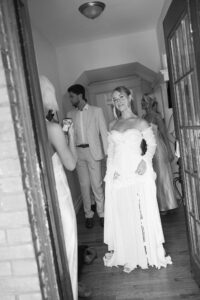 Brides celebrating their summer wedding at Wild Carrot in St. Louis with bridesmaids in pale yellow and chartreuse dresses and bridesmen in beige suits.