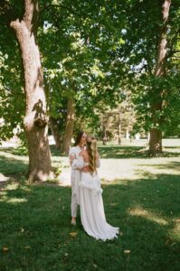 Bride and bride sharing a first look in Tower Grove Park before their Wild Carrot wedding in St. Louis.