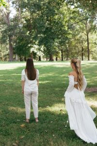 Bride and bride sharing a first look in Tower Grove Park before their Wild Carrot wedding in St. Louis.