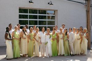 Modern LGBTQ wedding at Wild Carrot in St. Louis featuring pale yellow and chartreuse bridesmaid dresses, simple calla lily bouquets, and a brick reception space.