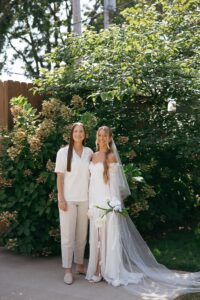 Modern LGBTQ wedding at Wild Carrot in St. Louis featuring pale yellow and chartreuse bridesmaid dresses, simple calla lily bouquets, and a brick reception space.