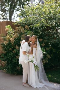 Modern LGBTQ wedding at Wild Carrot in St. Louis featuring pale yellow and chartreuse bridesmaid dresses, simple calla lily bouquets, and a brick reception space.
