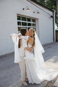Modern LGBTQ wedding at Wild Carrot in St. Louis featuring pale yellow and chartreuse bridesmaid dresses, simple calla lily bouquets, and a brick reception space.