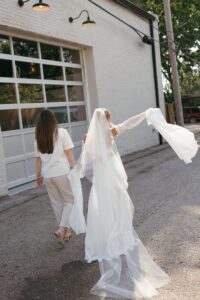 Modern LGBTQ wedding at Wild Carrot in St. Louis featuring pale yellow and chartreuse bridesmaid dresses, simple calla lily bouquets, and a brick reception space.