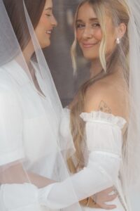 Modern LGBTQ wedding at Wild Carrot in St. Louis featuring pale yellow and chartreuse bridesmaid dresses, simple calla lily bouquets, and a brick reception space.