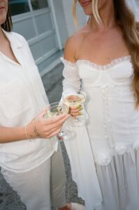 Modern LGBTQ wedding at Wild Carrot in St. Louis featuring pale yellow and chartreuse bridesmaid dresses, simple calla lily bouquets, and a brick reception space.