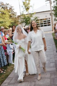 Outdoor sunset ceremony at Wild Carrot in St. Louis during a summer wedding with elegant calla lily flowers and a warm golden evening glow.