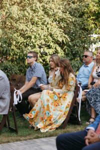 Outdoor sunset ceremony at Wild Carrot in St. Louis during a summer wedding with elegant calla lily flowers and a warm golden evening glow.