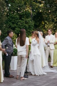Outdoor sunset ceremony at Wild Carrot in St. Louis during a summer wedding with elegant calla lily flowers and a warm golden evening glow.