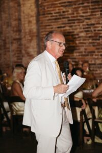 Outdoor sunset ceremony at Wild Carrot in St. Louis during a summer wedding with elegant calla lily flowers and a warm golden evening glow.
