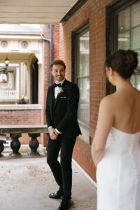 Bride and groom sharing a first look at an Airbnb before their St. Louis Art Museum wedding in Forest Park.