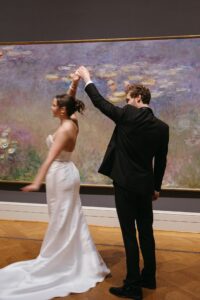 Intimate indoor ceremony during a rainy day St. Louis Art Museum wedding with pastel florals and pale blue bridesmaid dresses.