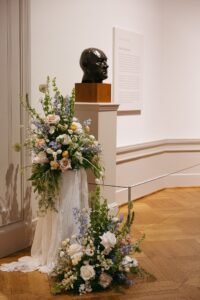 Intimate indoor ceremony during a rainy day St. Louis Art Museum wedding with pastel florals and pale blue bridesmaid dresses.