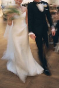 Intimate indoor ceremony during a rainy day St. Louis Art Museum wedding with pastel florals and pale blue bridesmaid dresses.