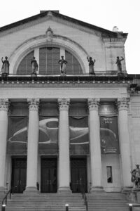 Intimate indoor ceremony during a rainy day St. Louis Art Museum wedding with pastel florals and pale blue bridesmaid dresses.