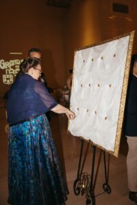 Elegant wedding reception inside the St. Louis Art Museum main hall with pastel floral arrangements and grand architecture.
