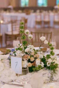 Elegant wedding reception inside the St. Louis Art Museum main hall with pastel floral arrangements and grand architecture.