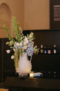 Elegant wedding reception inside the St. Louis Art Museum main hall with pastel floral arrangements and grand architecture.