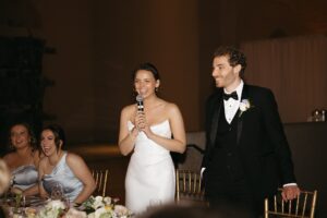 Elegant wedding reception inside the St. Louis Art Museum main hall with pastel floral arrangements and grand architecture.