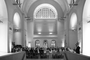 Elegant wedding reception inside the St. Louis Art Museum main hall with pastel floral arrangements and grand architecture.