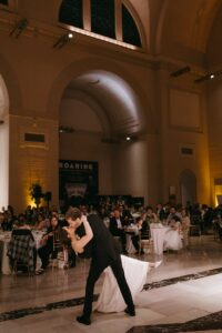 Elegant wedding reception inside the St. Louis Art Museum main hall with pastel floral arrangements and grand architecture.