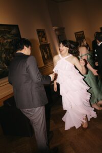 Elegant wedding reception inside the St. Louis Art Museum main hall with pastel floral arrangements and grand architecture.