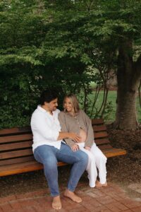 maternity photos of Jen wearing white linen pants and beige cardigan with bump visible at Queeny Park