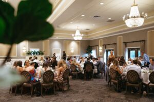 bride wearing her mother and grandmother's altered wedding dress at rehearsal dinner at Forest Hills Country Club