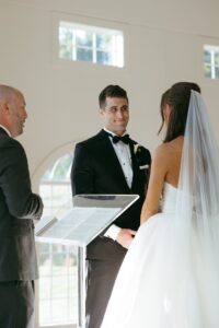 emotional indoor wedding ceremony in the chandelier room at Westwind Hills in St Louis