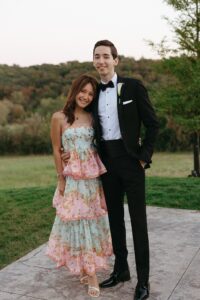 wedding guests enjoying outdoor cocktail hour near the stone fireplace at Westwind Hills