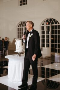 reception at Westwind Hills with black and white dance floor under large chandelier
