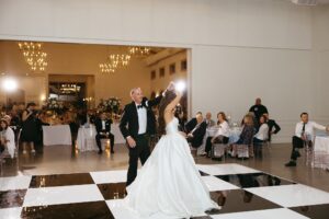 reception at Westwind Hills with black and white dance floor under large chandelier