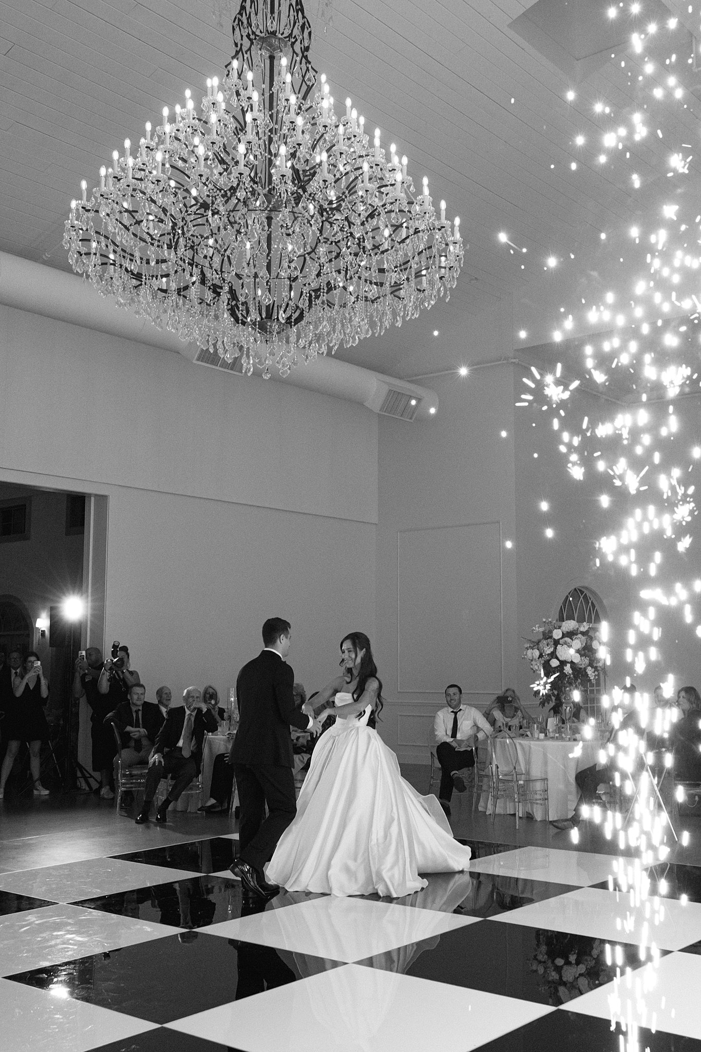 reception at Westwind Hills with black and white dance floor under large chandelier